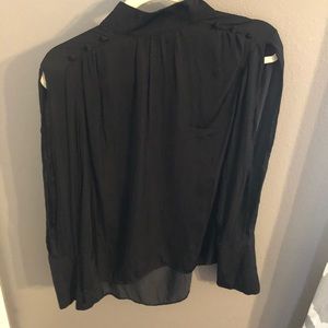 Dressy, high neck top with cut out down sleeve.